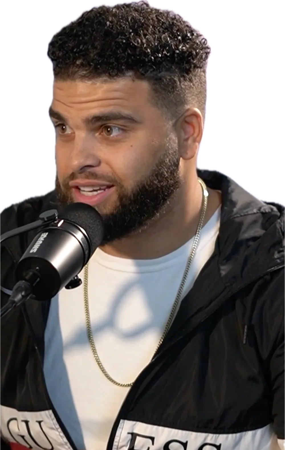 Coach Crim talking into a podcast microphone